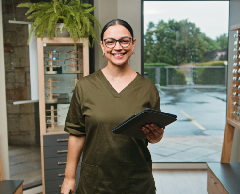 Optometrist Business Professional in Optical Store Holding Tablet