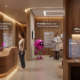 Modern ophthalmology clinic featuring magenta AI assistant orbs managing patient scheduling, clinical documentation, and billing workflows within an integrated EVAA AI ecosystem.